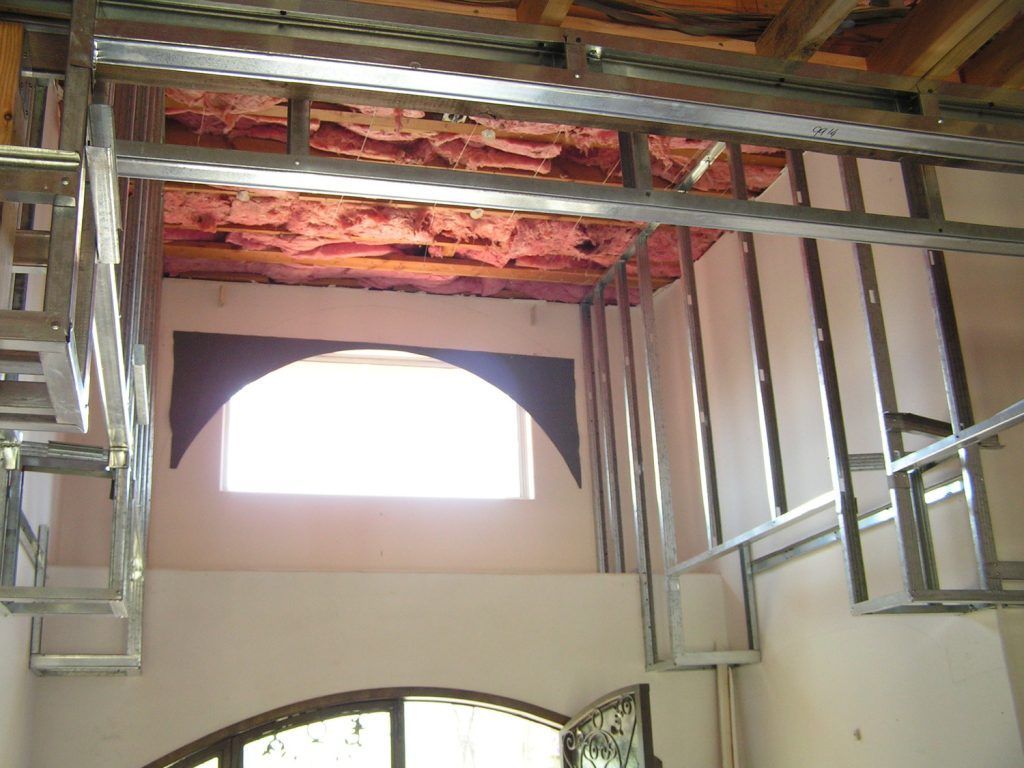 A room with a staircase and a window under construction