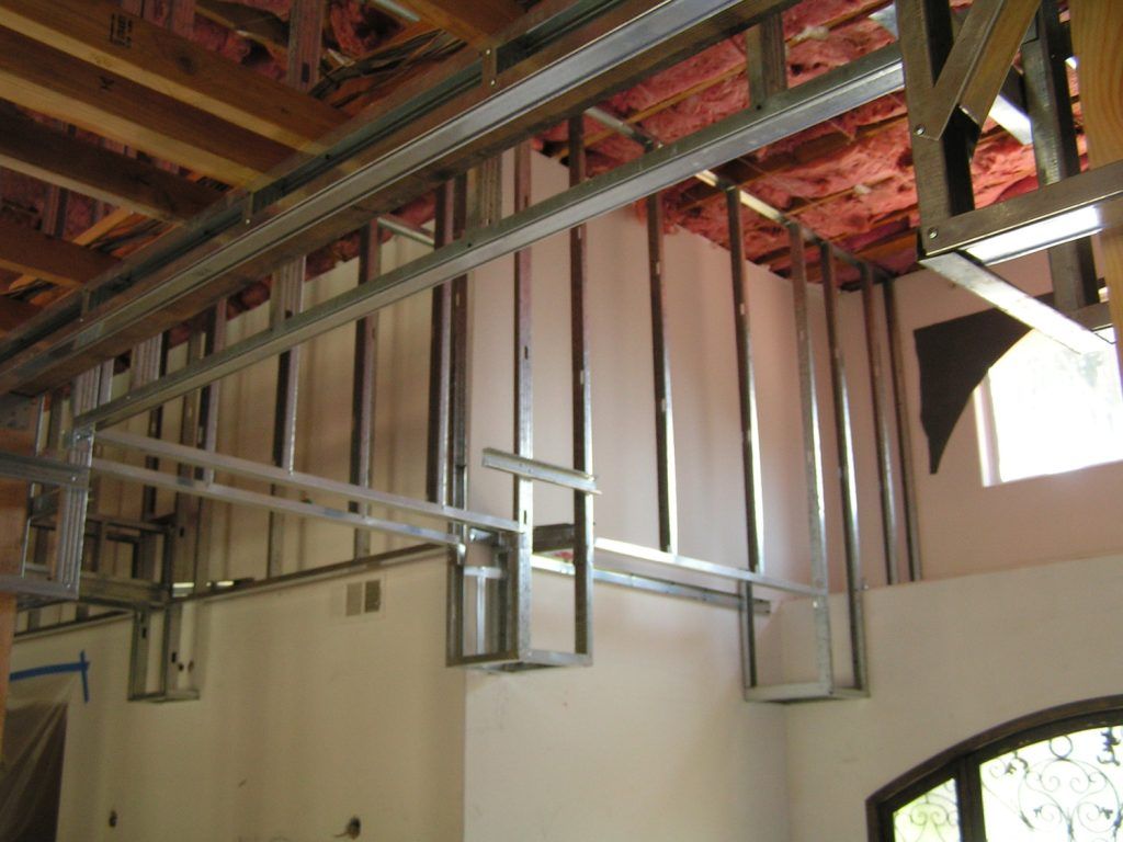 A room with a lot of metal frames and insulation on the ceiling