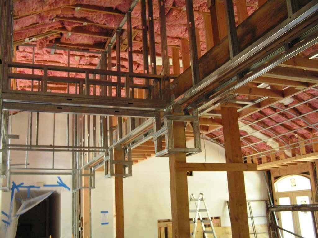 A building under construction with a ladder in the corner