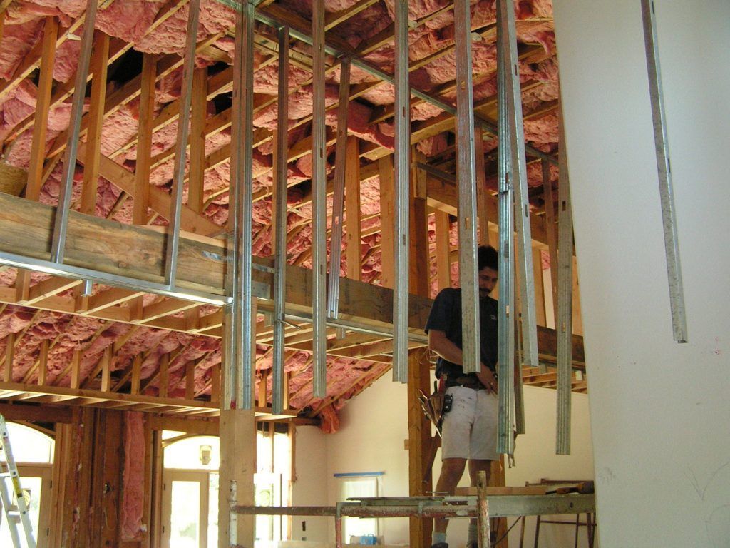 A man is standing in the middle of a building under construction
