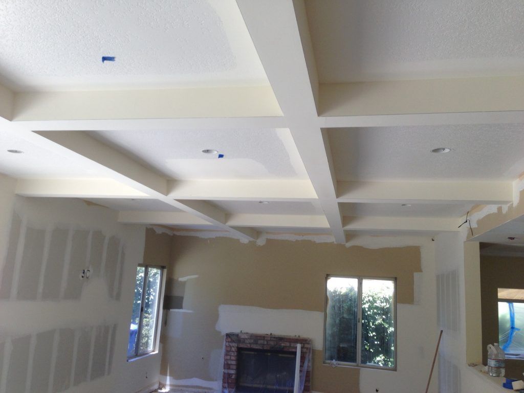 A living room with a fireplace and a white ceiling