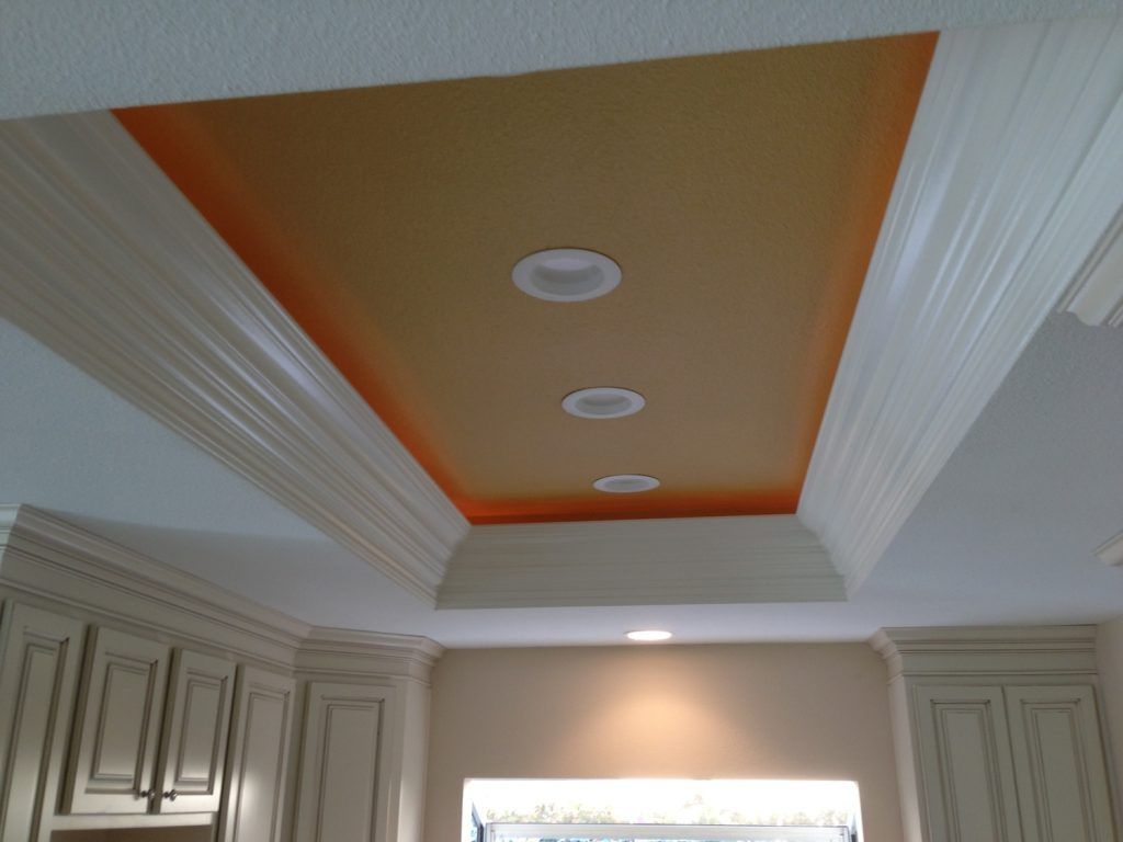 A kitchen with a ceiling that has three lights on it