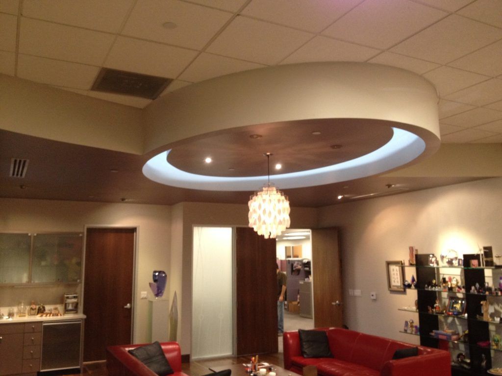 A living room with a round ceiling and a red couch