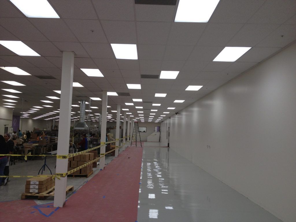 A large warehouse with lots of lights on the ceiling