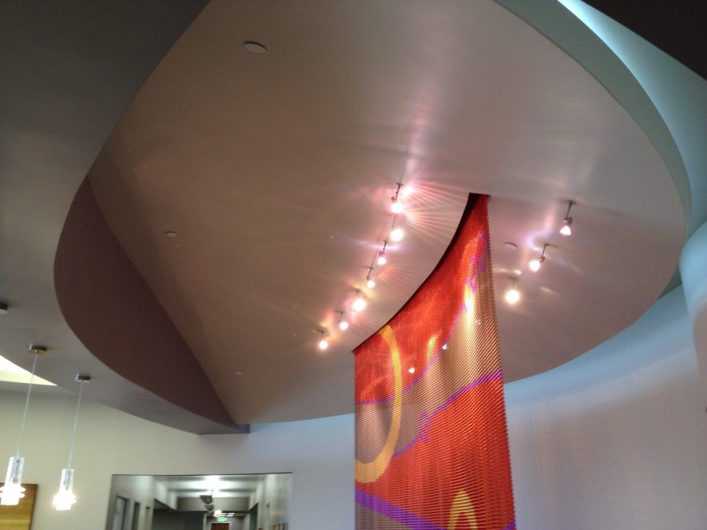 A ceiling with a red and purple banner hanging from it