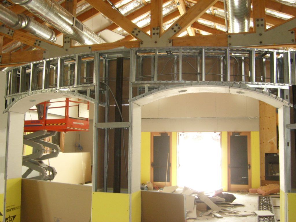 A building under construction with a ladder in the background