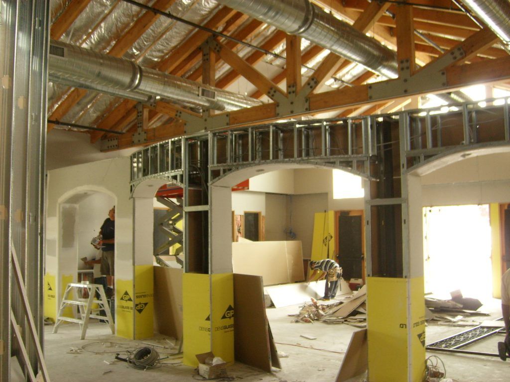A building under construction with a ladder in the middle