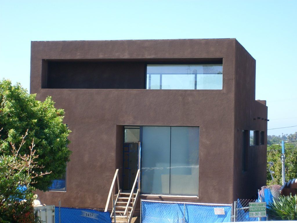 A large brown building with stairs leading up to it