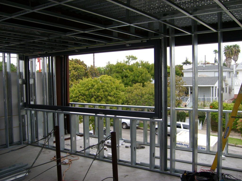A building under construction with a ladder in the foreground