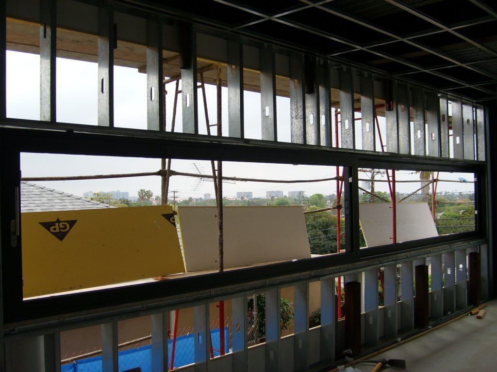 A building under construction with a yellow sign that says dn on it