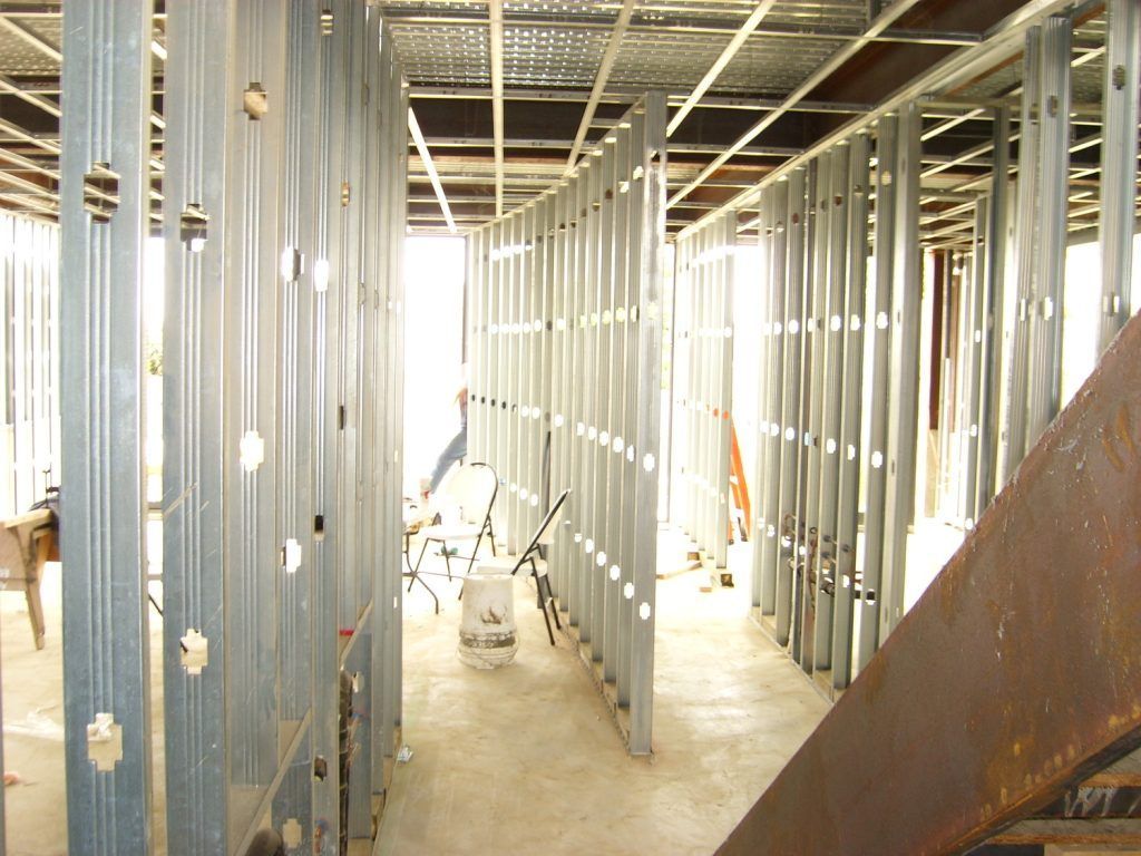 The inside of a building under construction with a staircase in the background