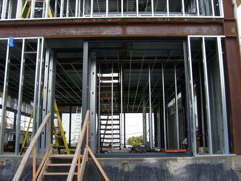 A building under construction with stairs leading up to it
