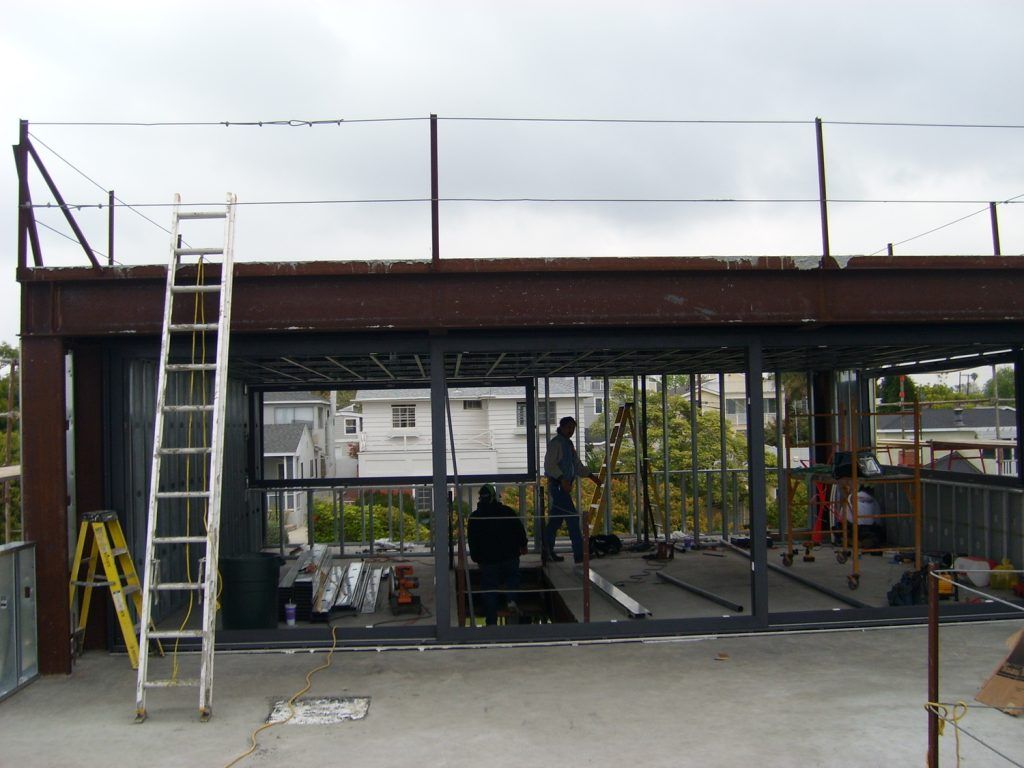 A building under construction with a ladder on the side