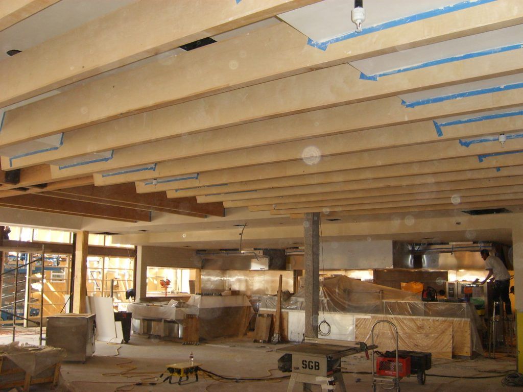 A large room with a ceiling that has tape on it