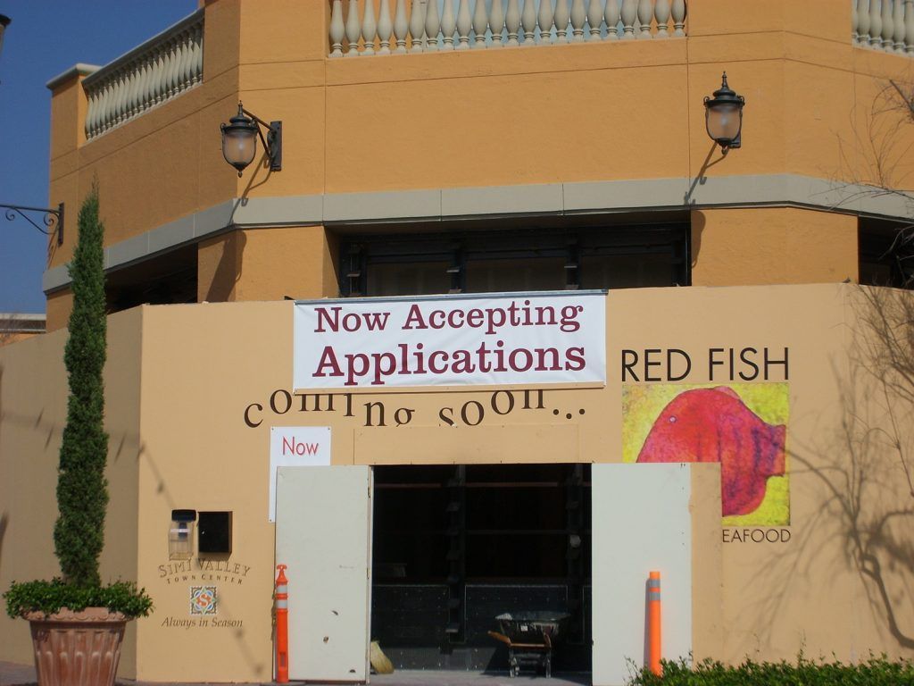 A building with a sign that says now accepting applications
