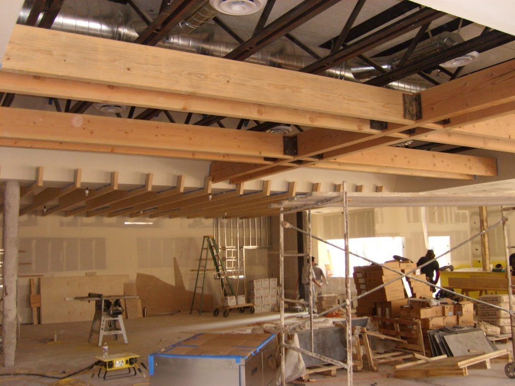 A room with a lot of wooden beams and scaffolding