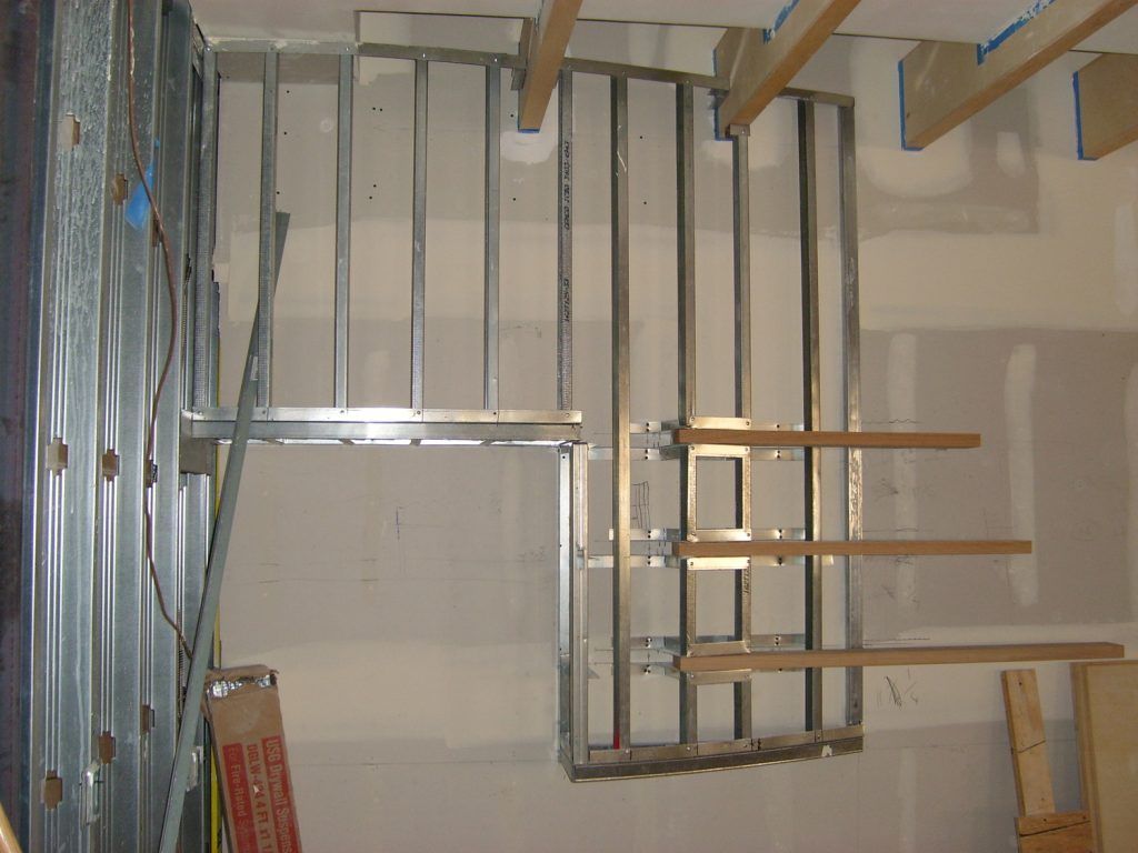 A wall with a metal frame and a cardboard box that says ' aluminum ' on it