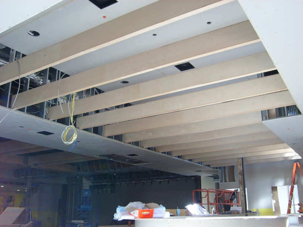 The ceiling of a building is being built with wooden beams