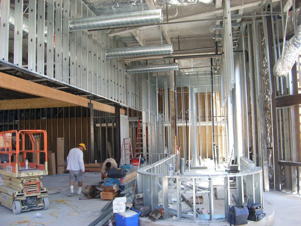 A man is standing in the middle of a building under construction