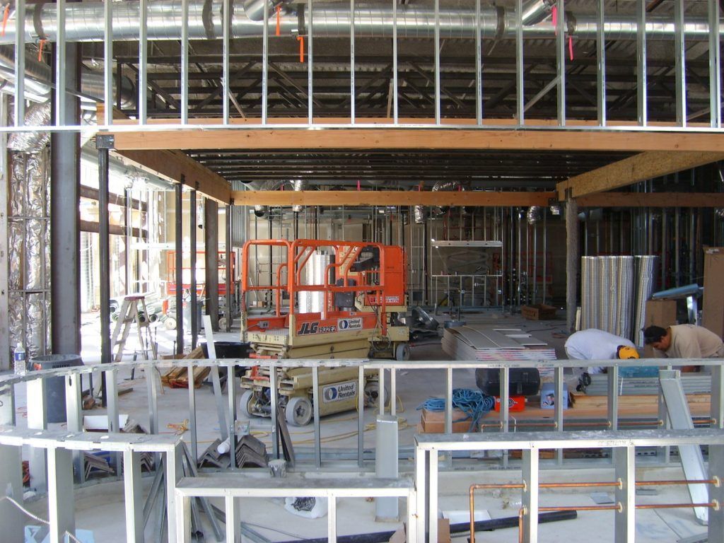 A construction site with a jlg lift in the background