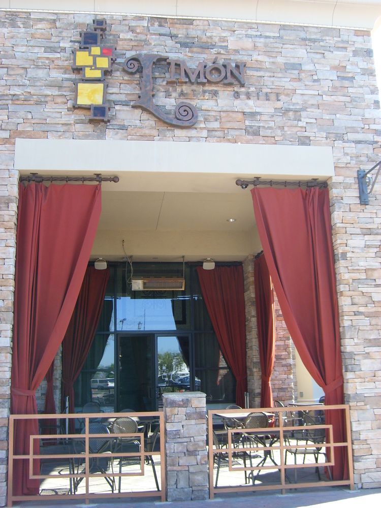 A restaurant with red curtains and a sign that says simon