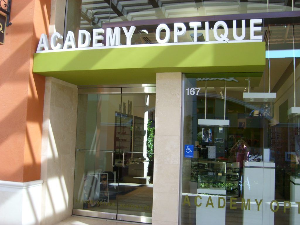 Academy optique has a green awning over the entrance