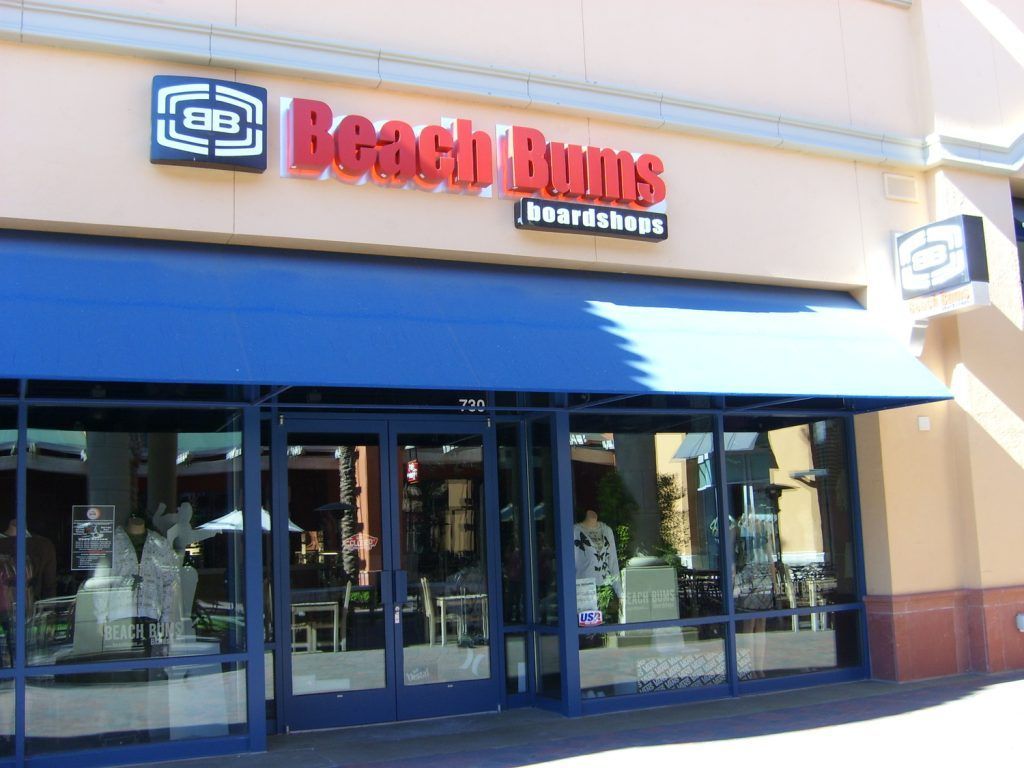 A beach buns restaurant with a blue awning