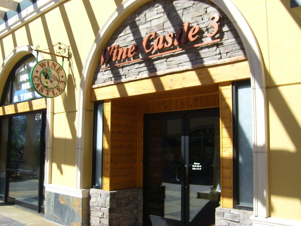 A yellow building with a sign that says wine castle
