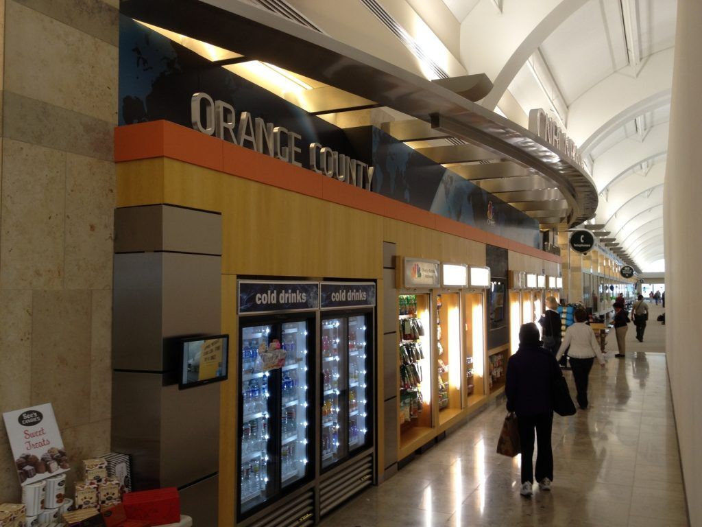 A woman walks past a store called the orange lounge
