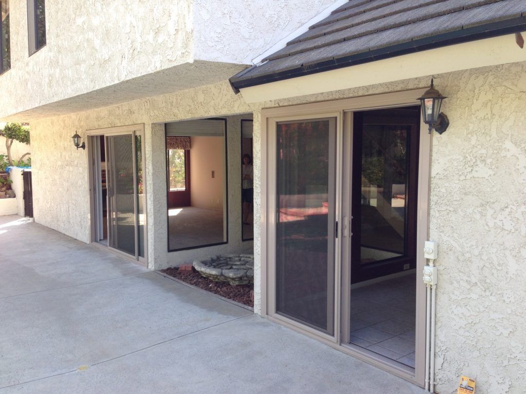 A house with a lot of windows and sliding glass doors