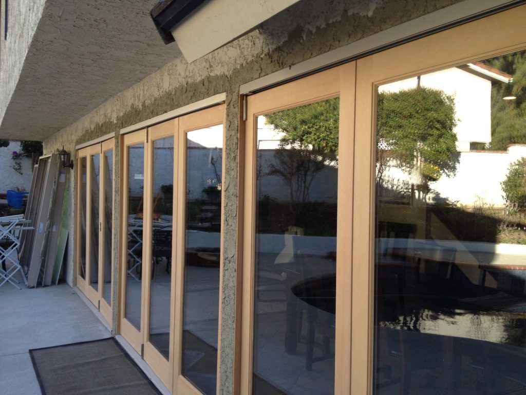 A row of sliding glass doors on the side of a building