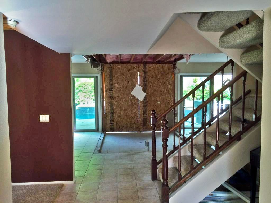 An empty room with stairs leading up to the second floor