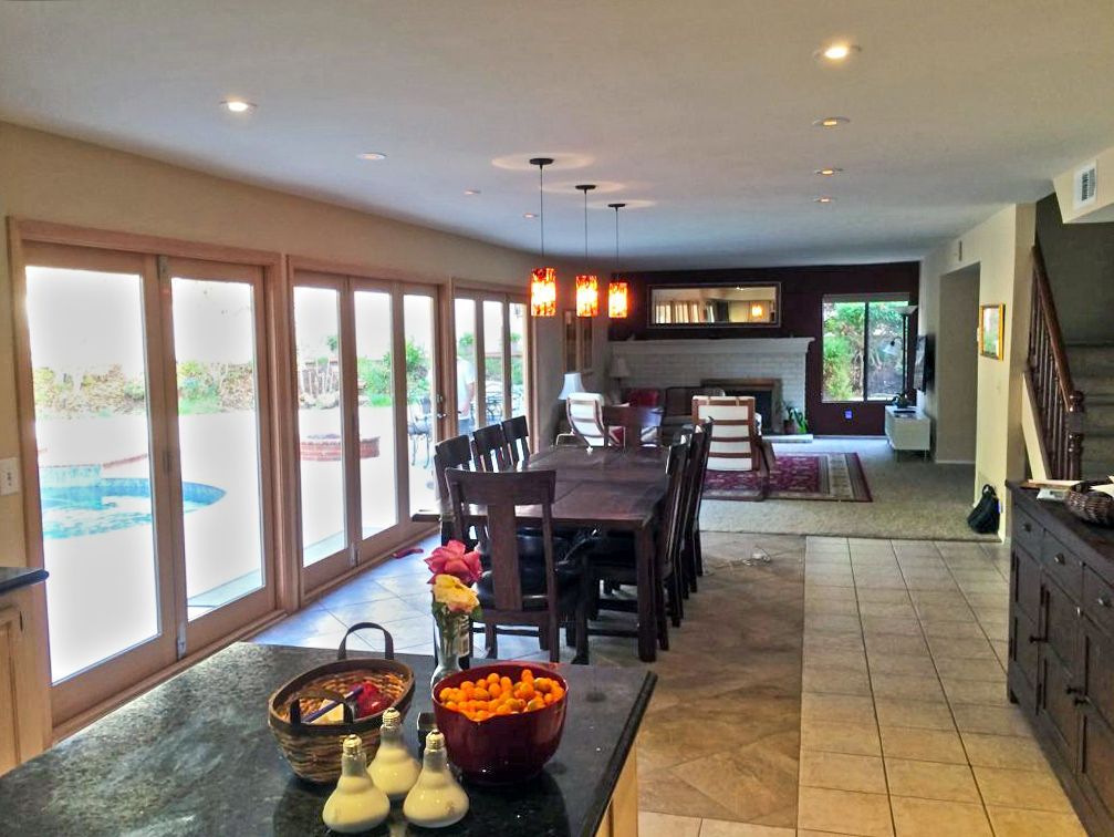 A kitchen with a long dining table and chairs