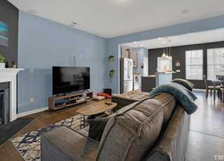 A living room with a couch , television and fireplace.