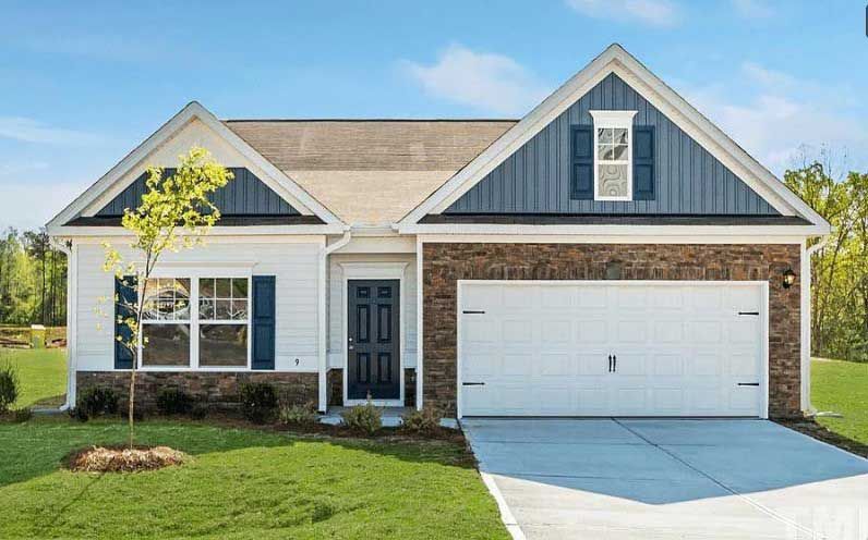 A white house with a blue roof and black shutters is for sale.