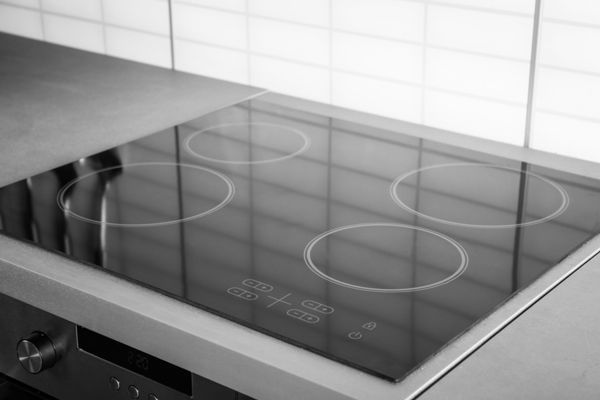 a black and white photo of a stove top oven