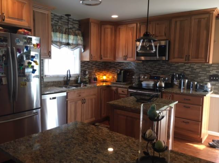 A kitchen with stainless steel appliances and wooden cabinets