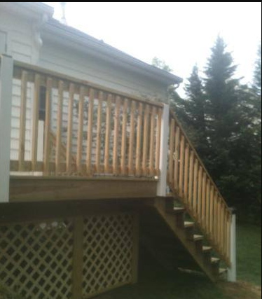 A wooden deck with stairs leading up to it