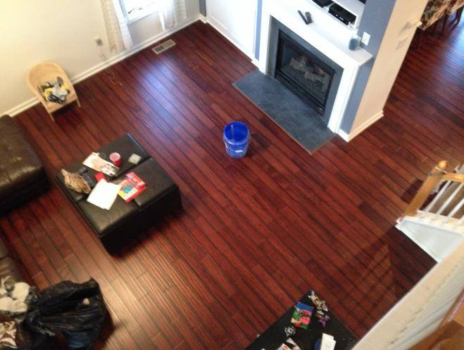 An aerial view of a living room with hardwood floors and a fireplace
