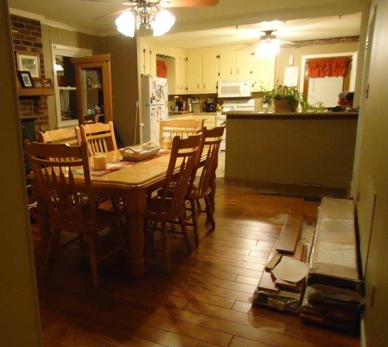 A kitchen with a table and chairs and a ceiling fan