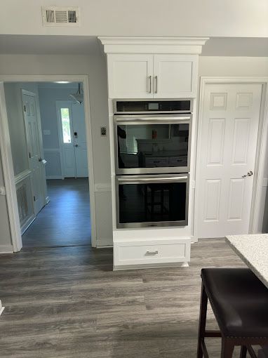 There is a double oven in the middle of the kitchen.