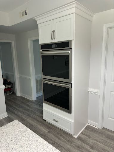 There is a double oven in the middle of the kitchen.