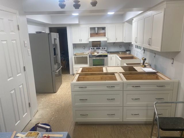 A kitchen with white cabinets and wooden sinks