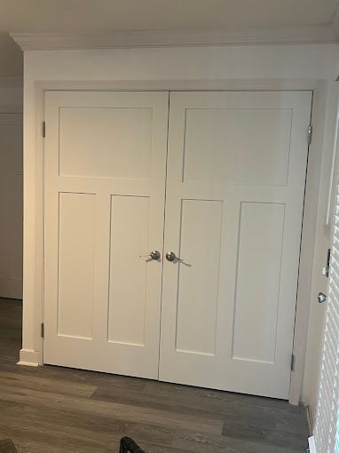 There are two white doors in the closet.