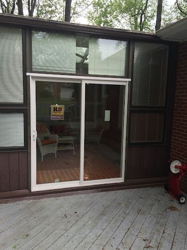 A sliding glass door is open to a living room.