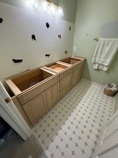 A bathroom with two sinks and a tiled floor.