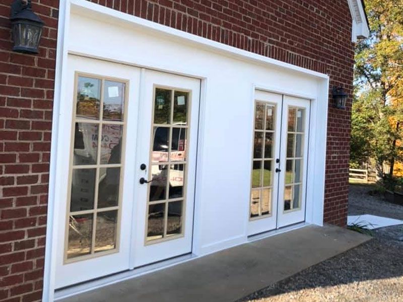 A red brick building with white doors and windows