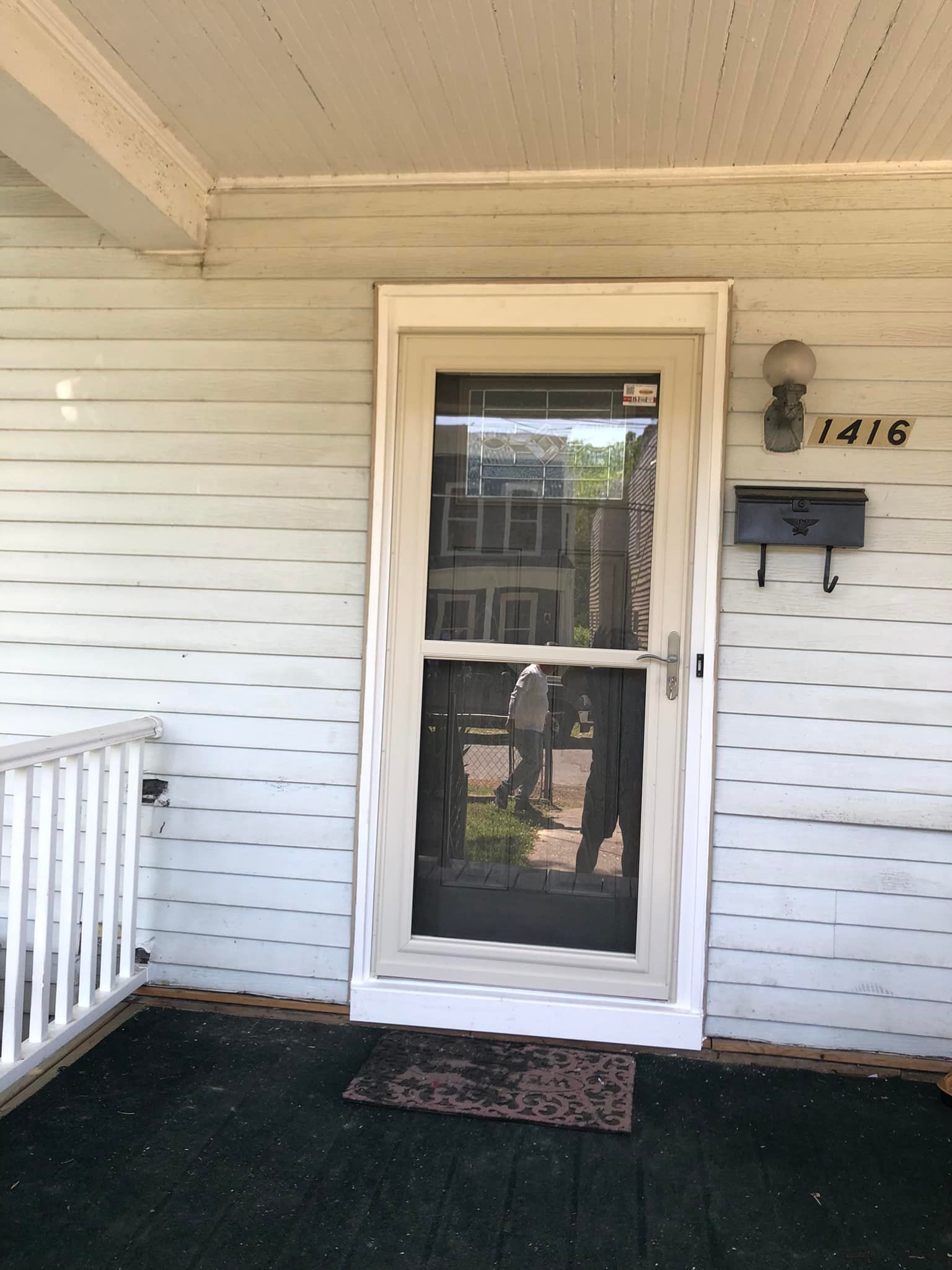 The front door of a house has the number 1416 on it
