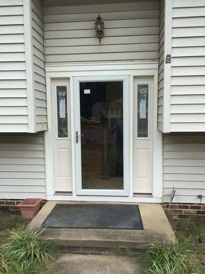 The front door of a house with a sliding glass door.