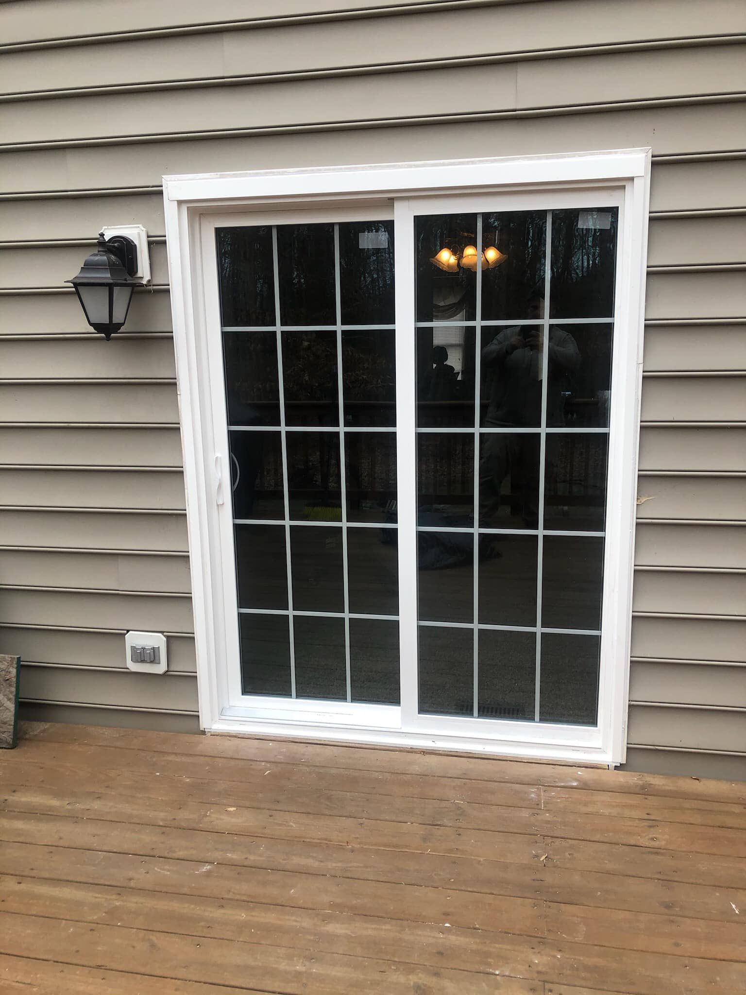 A sliding glass door on the side of a house